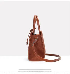 Detail of caramel leather and suede patchwork bag with silver metal hooks and side view