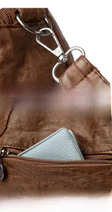 Close-up of litchi texture leather bag with metal hooks and a rear zipper pocket