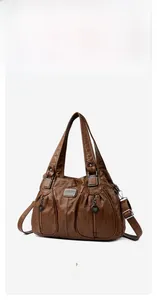 Detail of a brown vintage tote bag featuring dual front zipper pockets and top handles