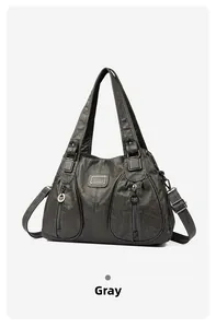 Detail view of large grey shoulder bag with double zipper pockets and metal logo hardware