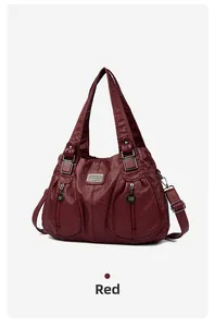 Detail of red faux leather tote bag with vintage texture and double zipper pockets