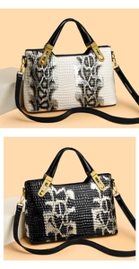 Detail of crocodile pattern texture on beige and black handbags with gold metal accents