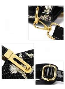 Detailed macro view of shiny gold metal hardware and crocodile texture on the fashion handbag