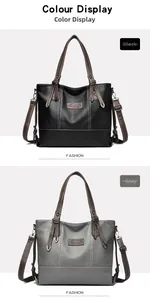 Detail view of lychee leather tote bags in black and grey with white contrast stitching