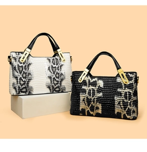 Detail of crocodile and snake texture handbags with gold metal U-shaped buckles