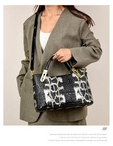 Fashionable black and white crocodile texture handbag styled with a grey business suit
