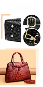Detail of red crocodile texture handbag with golden hardware and adjustable strap