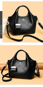 Detailed view of black quilted bucket bag with kangaroo logo and detachable pouch