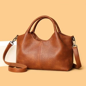 Brown vintage faux leather tote bag with top handles and adjustable shoulder strap