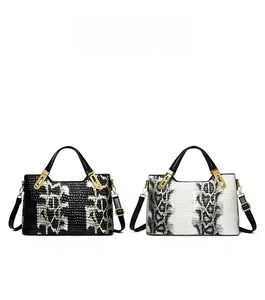 Detailed comparison of black and white faux crocodile skin texture on tote bags