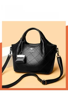 Macro detail of black quilted leather bucket bag with silver kangaroo logo and mini pouch