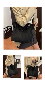 Detail of black suede bucket bag featuring golden chain strap and drawstring design