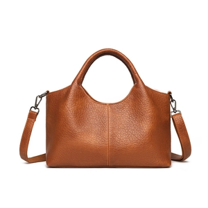 Brown lychee leather tote bag with dual handles and detachable shoulder strap on white
