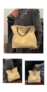 Detail of beige suede tote bag with black leather handles and golden chain strap