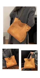 Detail of brown suede bucket bag with leather chain strap and drawstring design