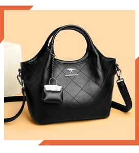Detail of black lychee grain leather bucket bag with silver kangaroo logo and stitching