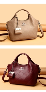 Detailed view of bucket bag with diamond stitching and metal kangaroo emblem