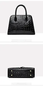 Detail view of black crocodile pattern tote bag showing base studs and back stitching
