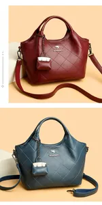 Detail of vintage bucket bags in wine red and blue grey with litchi grain and diamond stitching