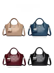Detail view of four textured leather bucket bags in khaki, blue, red and black