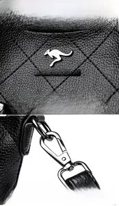 Detail of black quilted leather with kangaroo logo and silver metal hardware attachments