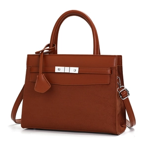 Elegant cognac leather and suede tote bag with top handles and adjustable shoulder strap