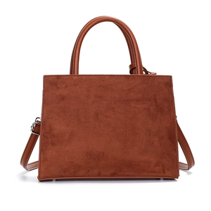 Brown vintage suede handbag with top handles and adjustable shoulder strap on white background