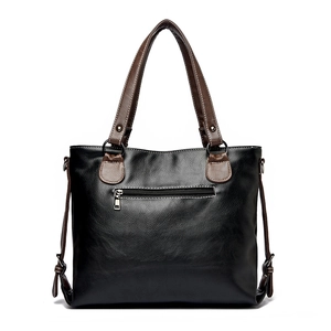 Sac fourre-tout minimaliste en cuir noir avec anses brunes, vue de l'arrière