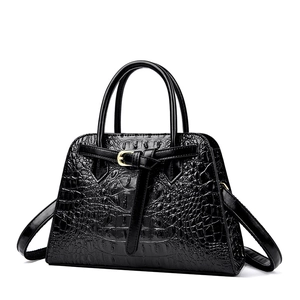 Classic black crocodile pattern tote bag with gold buckle detail and sturdy round handles