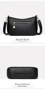 Dettaglio borsa in pelle nera con cerniera a cuore e logo del marchio sul fondo
