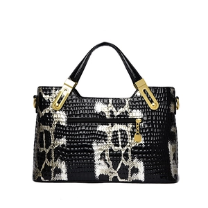 Classic black and white snake skin pattern tote bag with gold hardware and top handles