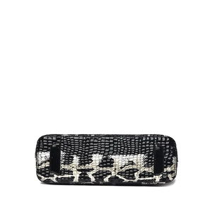 Bottom view of crocodile pattern handbag showing glossy texture and reinforced base