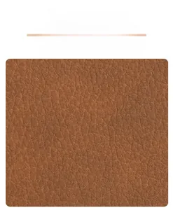 Detailed view of the brown lychee pattern leather texture on a stylish handbag