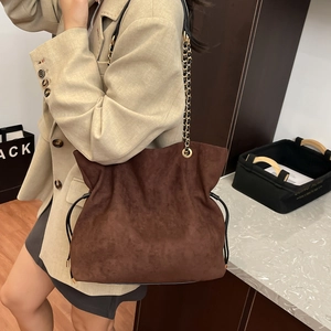 Brown faux suede drawstring bucket bag with gold chain strap for women casual style
