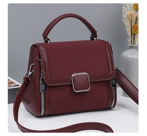 Detailed macro view of dark burgundy matte leather texture and square metal buckle
