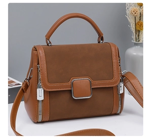 Close-up of caramel faux leather and suede texture on a modern women's handbag