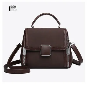 Detail of coffee brown crossbody bag showing smooth leather and suede texture contrast