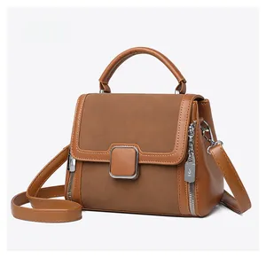 Micro side view of tan leather handbag featuring matte texture and metal buckle