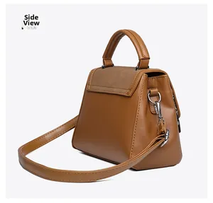 Side view detail of a tan leather handbag showing silver hardware and stitching