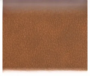 Macro close-up of premium brown leather texture with lychee grain pattern on handbags