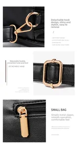 Close-up view of premium golden hardware details on a stylish black leather handbag