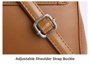 Macro detail of brown leather bag with adjustable silver metal strap buckle and fine stitching