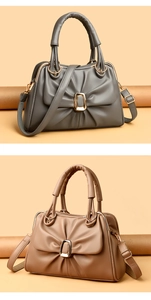 Detail view of large-capacity pleated cross-body bags in dark grey and camel faux leather