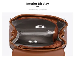 Interior view of brown leather handbag featuring dual compartments and herringbone lining
