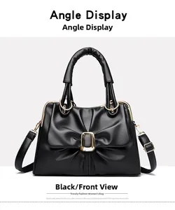 Front view of black leather handbag featuring a pleated bow design and gold metal buckle