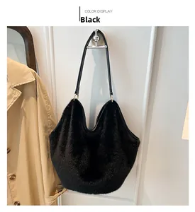 Close-up of black plush tote bag texture with sleek leather strap and metal hardware