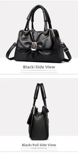 Detail of black pleated PU leather handbag with gold clasp and adjustable shoulder strap