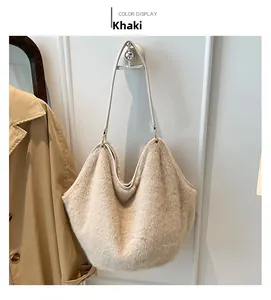 Detail of khaki faux fur hobo tote bag hanging against a minimal white background