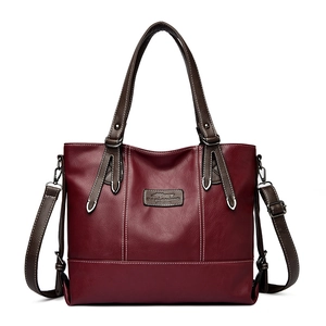 Burgundy PU leather tote bag with white contrast stitching and brown handles