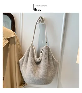 Close-up of grey plush leopard tote bag with white leather straps in a home setting